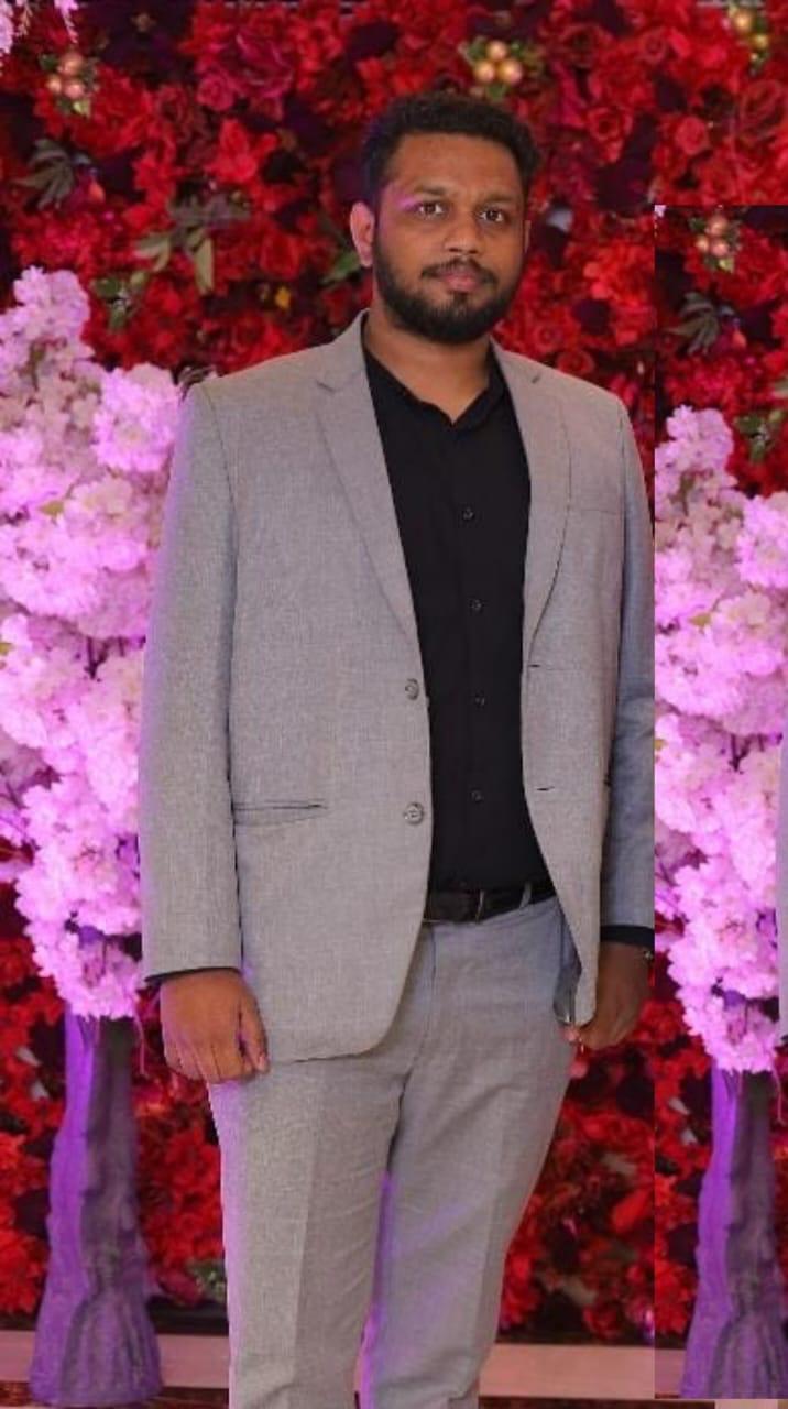 Harsh Srivastava in a grey suit at a celebration